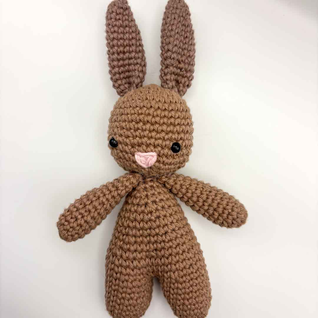 Brown crocheted bunny toy on a white background_Just Makers