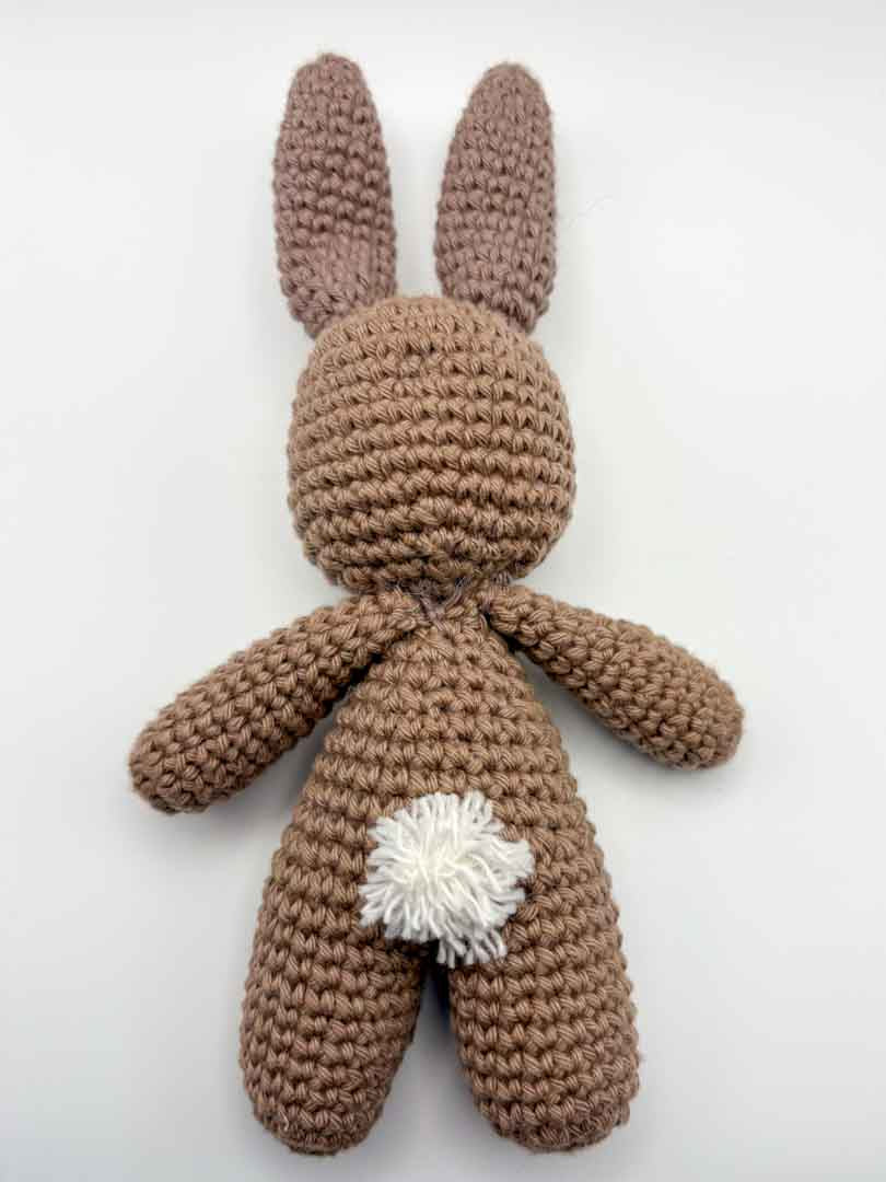 Brown crocheted bunny toy on a white background_Just Makers