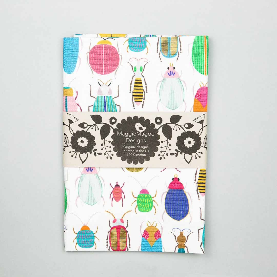 Tea towel with colorful bug pattern on a gray background_Maggie Magoo Designs_Just Makers