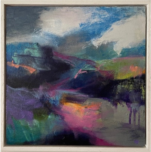 An abstract landscape painting featuring a dramatic sky with blue, white, and gray clouds, and a dark, shadowy mountain range with vibrant purple, pink, green, and orange brushstrokes below, housed in a light-colored wooden frame.