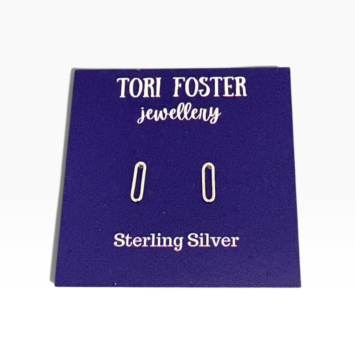 Sterling silver paperclip stud earrings on a purple Tori Foster Jewellery display card, photographed against a white background.