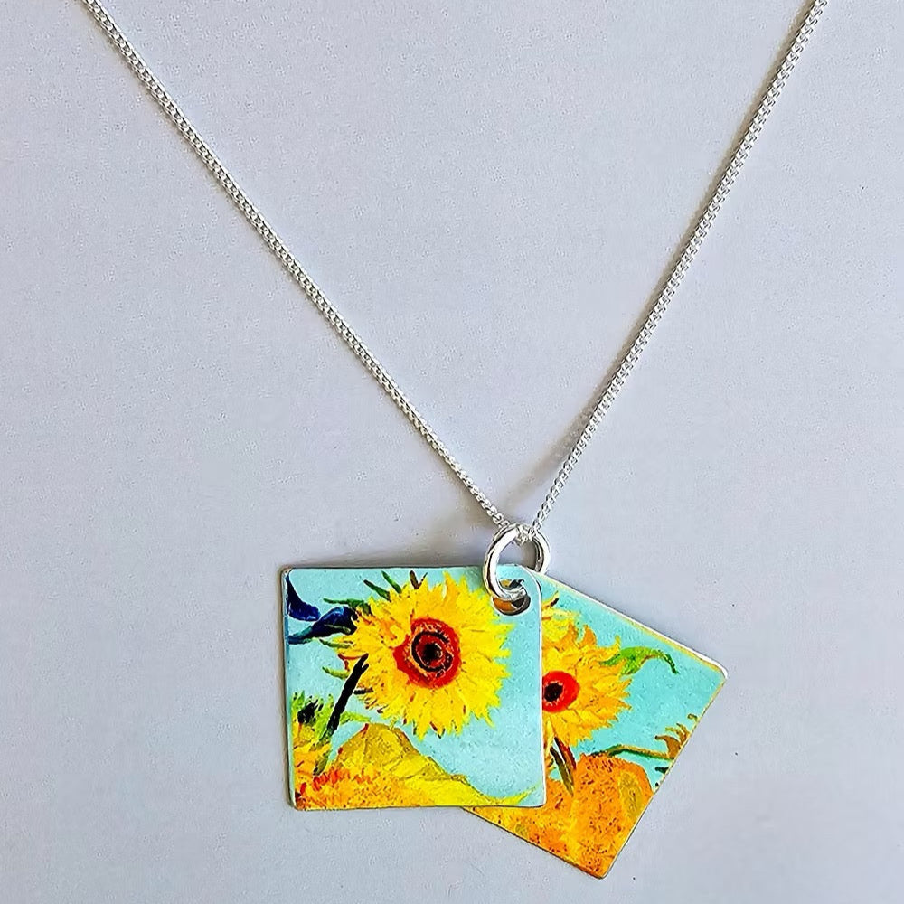 Necklace with a pendant featuring sunflower designs on a light gray background_Nancy Jones_Just Makers