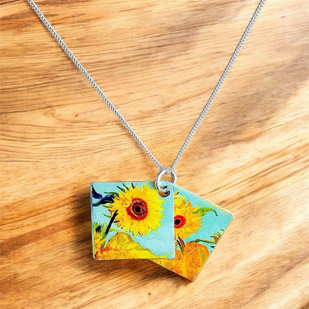 Necklace with a pendant featuring sunflower designs on a light gray background_Nancy Jones_Just Makers