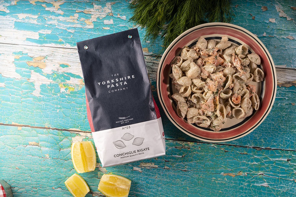 Pasta packaging and bowl of pasta on a rustic wooden surface_The Yorkshire Pasta Company_Just Makers