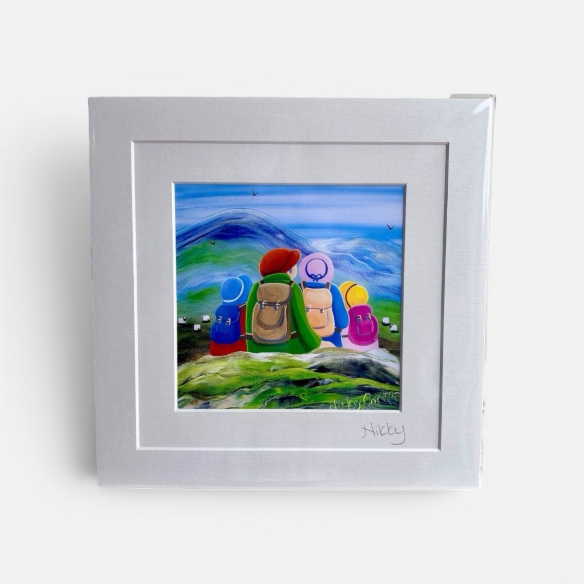 Framed artwork of colorful characters with backpacks against a mountainous landscape.