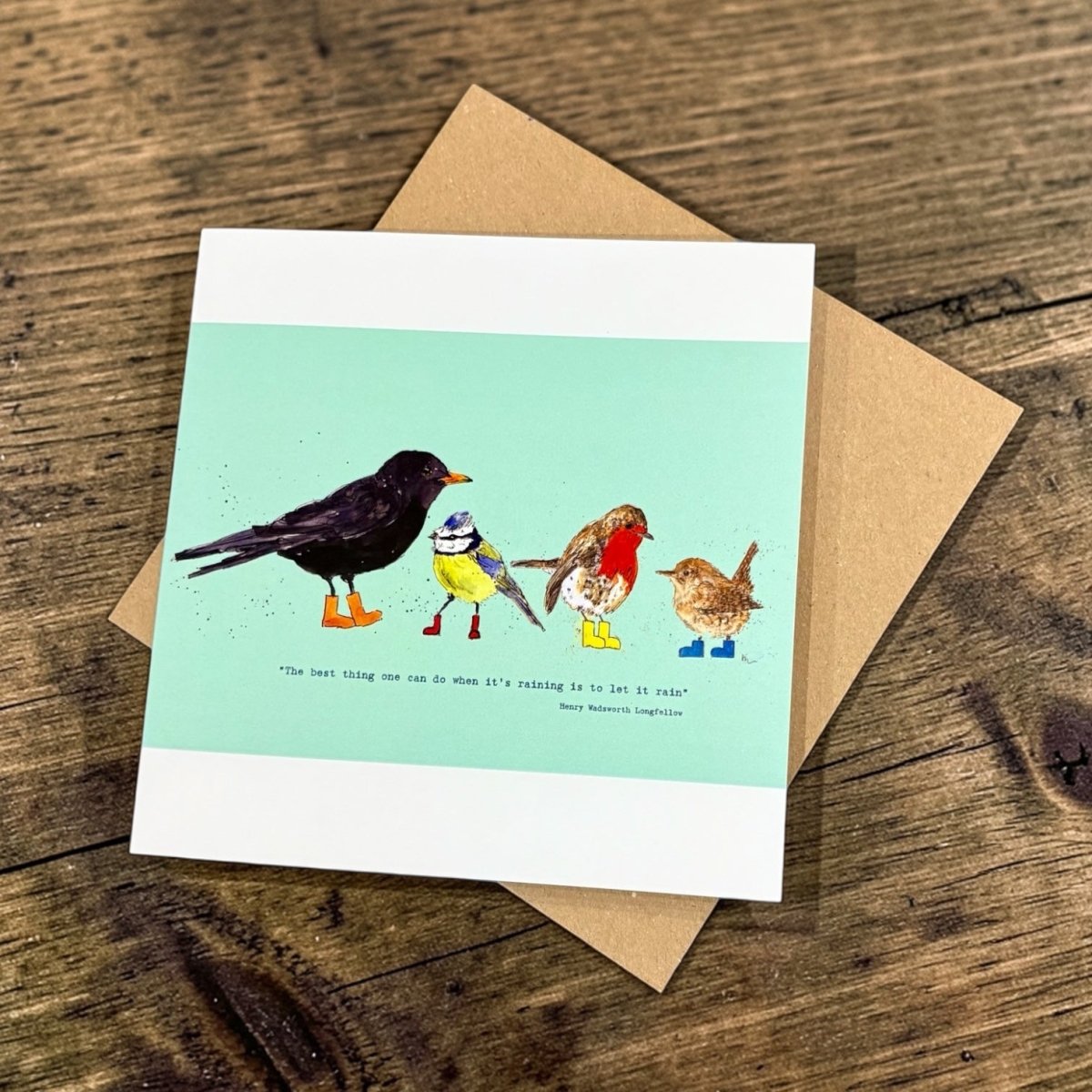 Card with bird illustrations on a wooden surface
