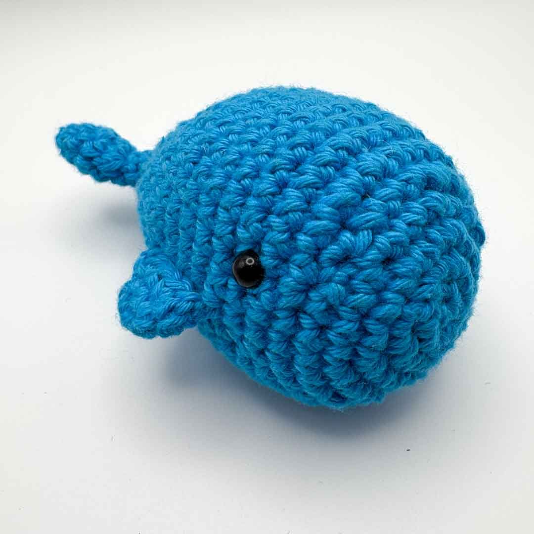 Blue crocheted whale toy on a white background_Just Makers