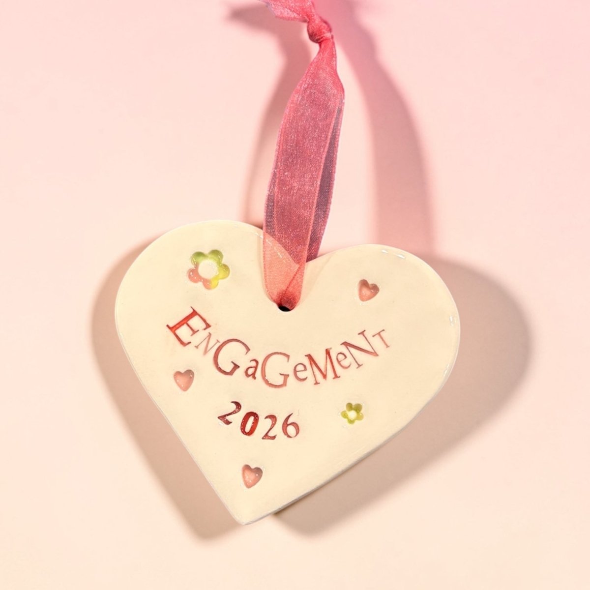 Heart-shaped engagement ornament with &