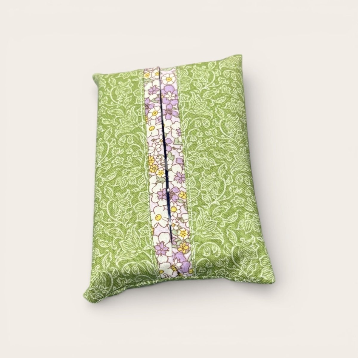 Green patterned pillow with a floral stripe on a white background