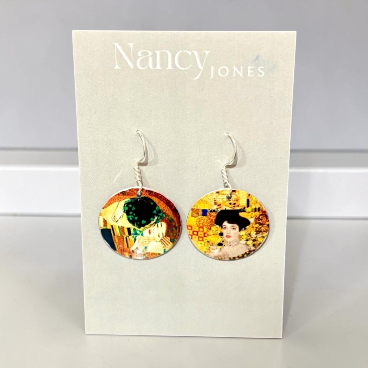 Nancy Jones earrings on a display card with artistic design