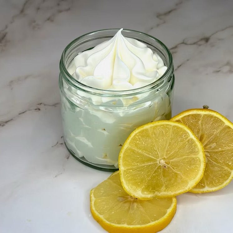 Jar of whipped cream with lemon slices on a marble surface