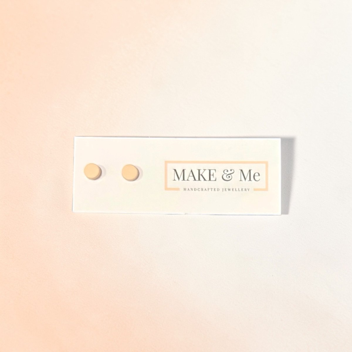 Make & Me earrings on a gradient background