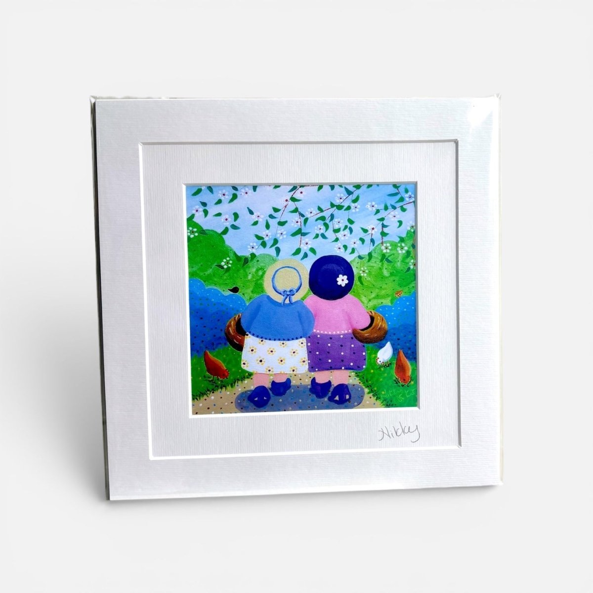 Framed artwork of two figures in a garden setting with a white border.