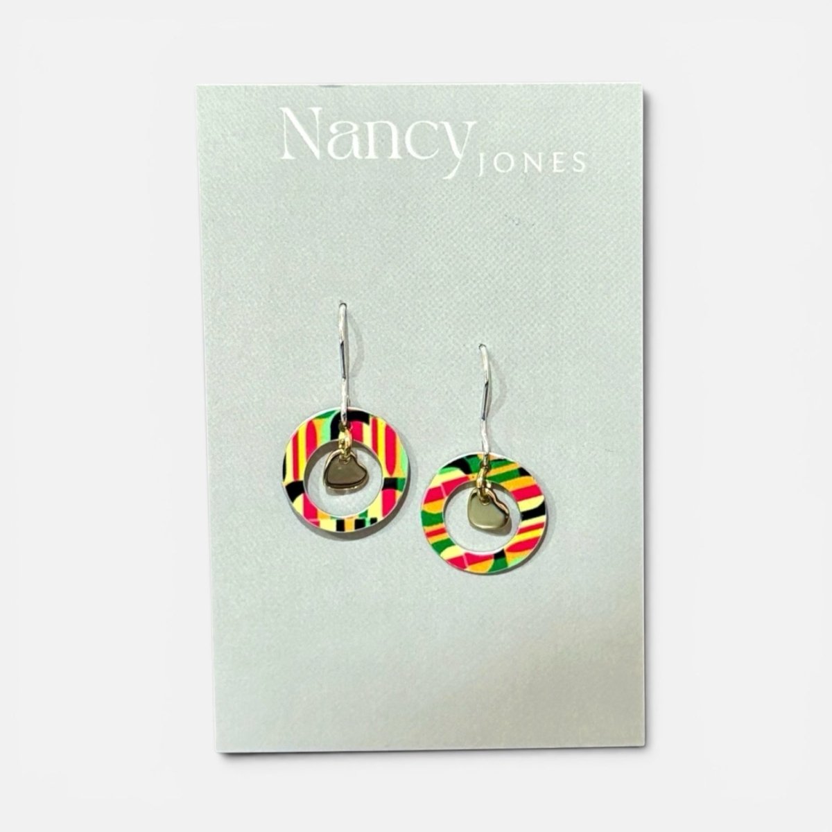 Colorful earrings on a Nancy Jones card against a white background