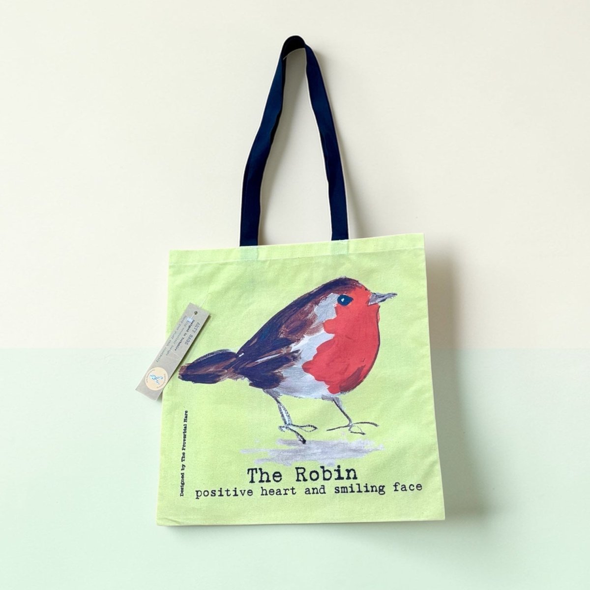 Tote bag with a robin design on a light green background