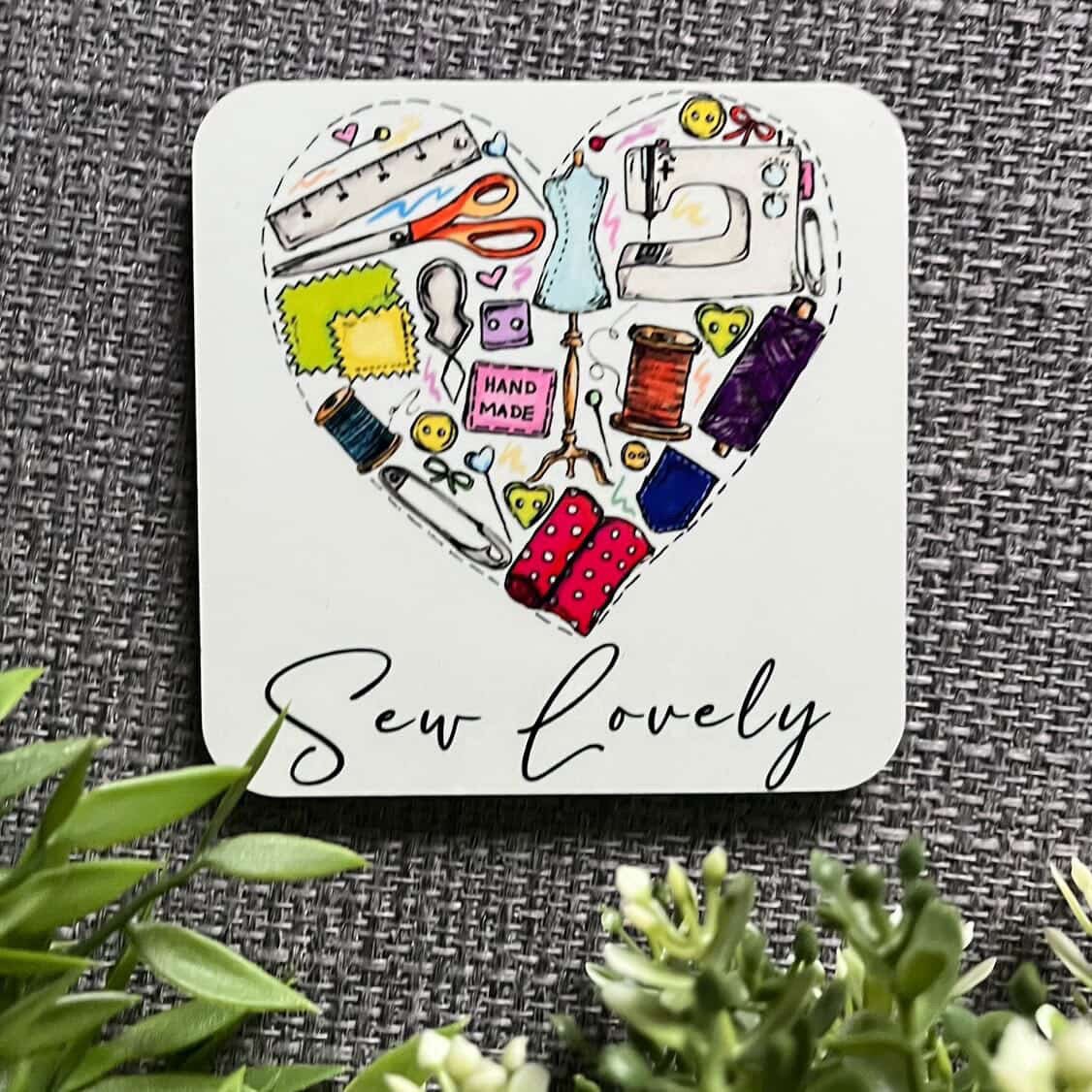 Heart-shaped coaster with sewing-themed illustrations and &
