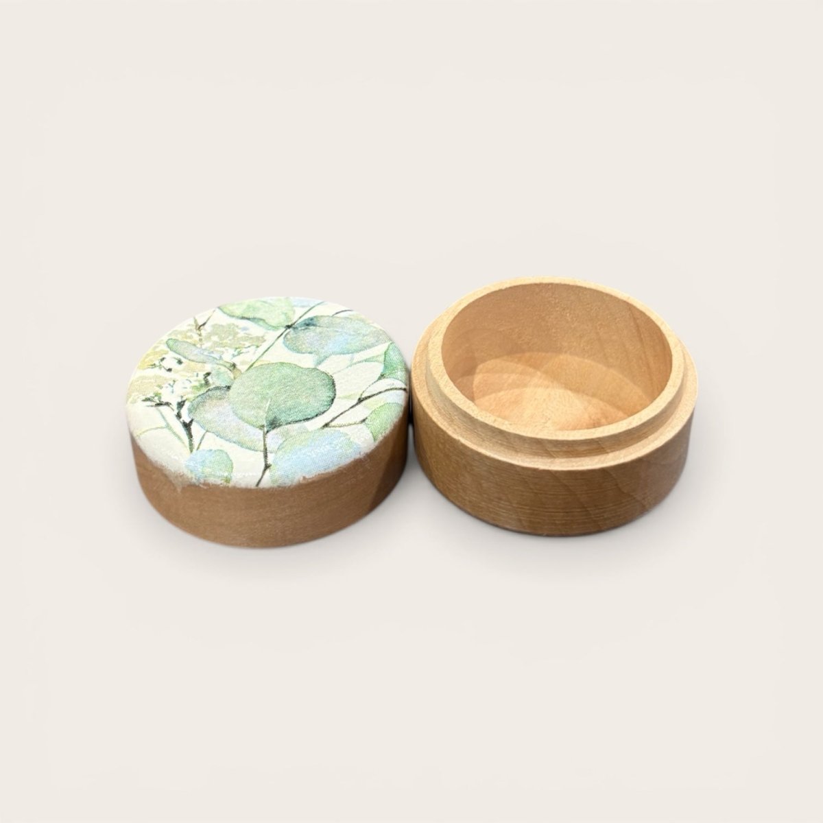 Wooden box with a floral lid on a light background