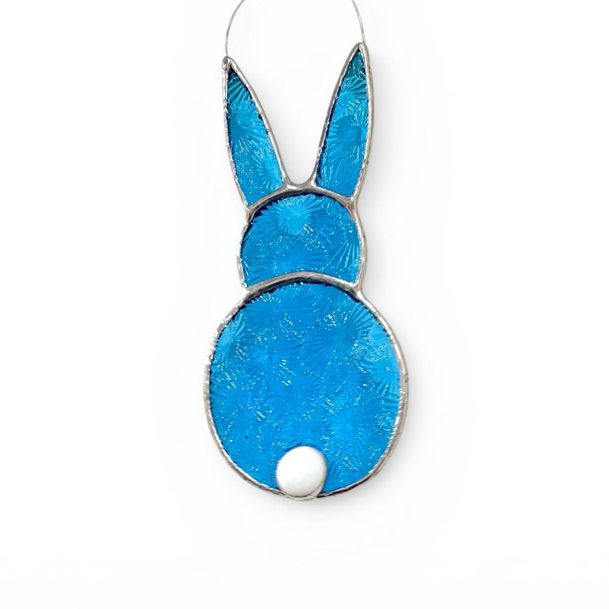 Blue glass bunny-shaped ornament on a white background