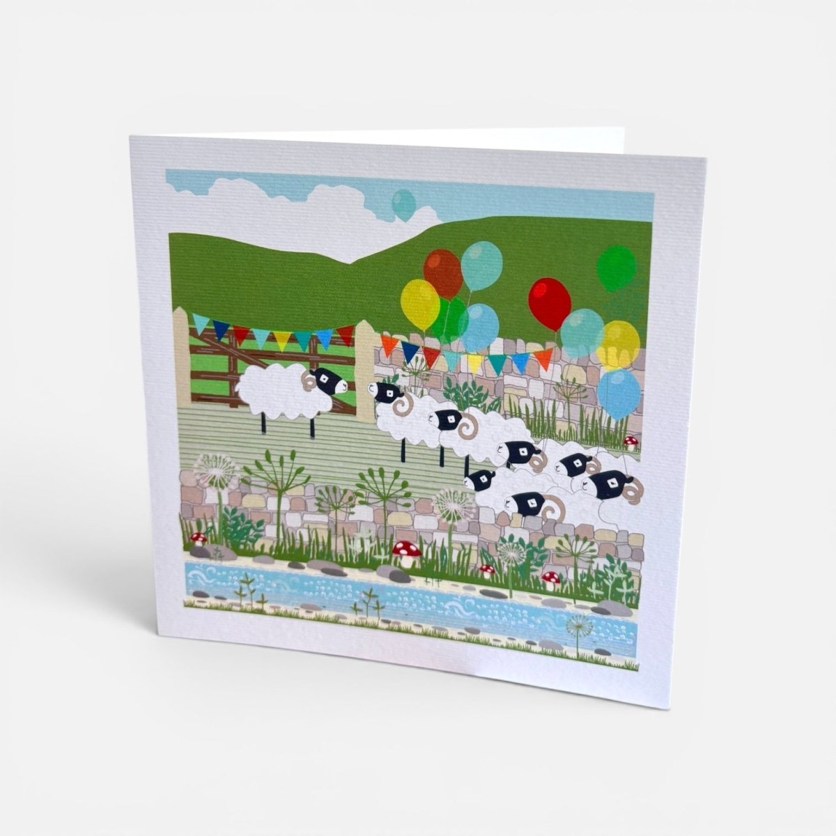 Greeting card with sheep and balloons design on a white background