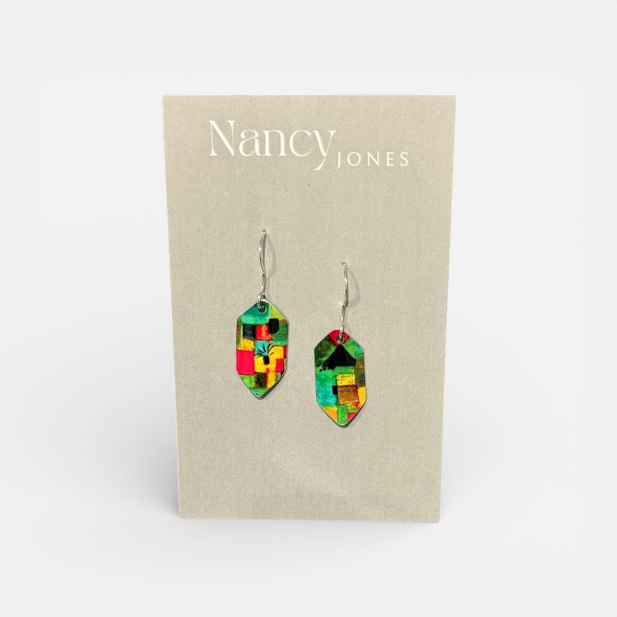 Colorful geometric earrings on a Nancy Jones branded card.