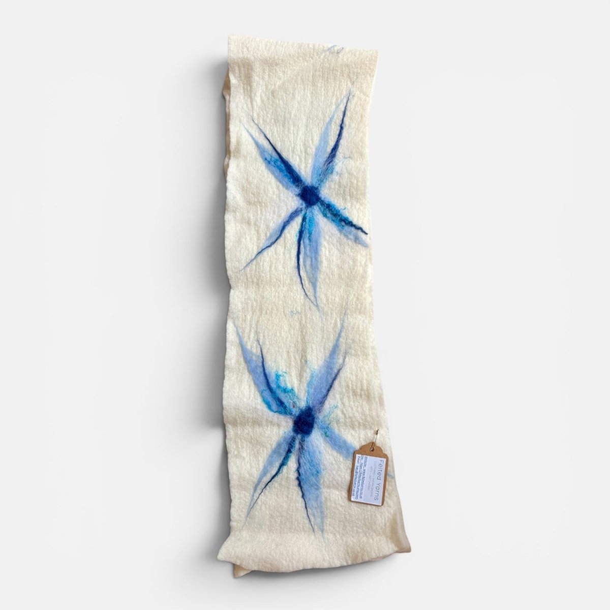 Folded fabric with blue starburst pattern on a white background