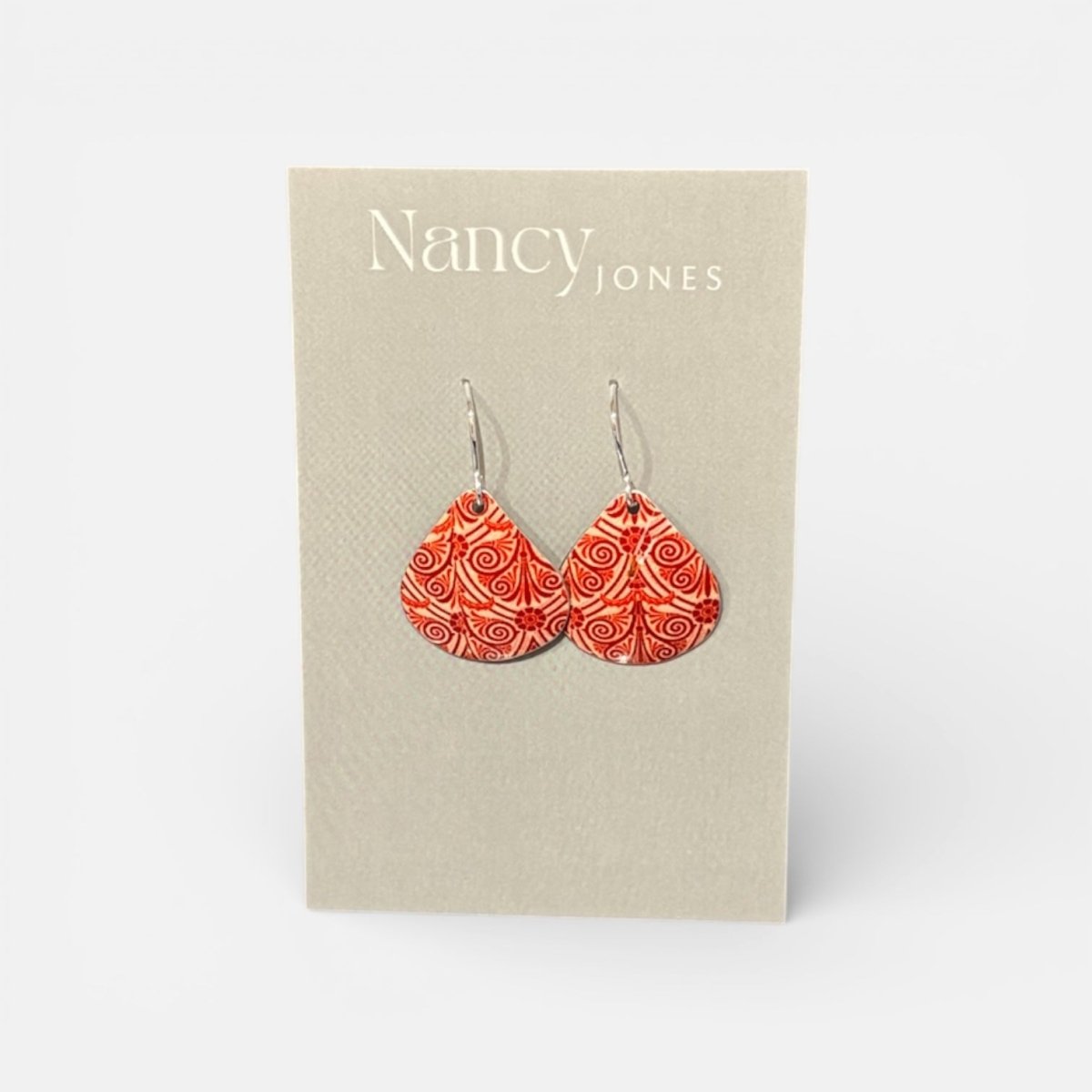 Orange patterned earrings on a Nancy Jones card