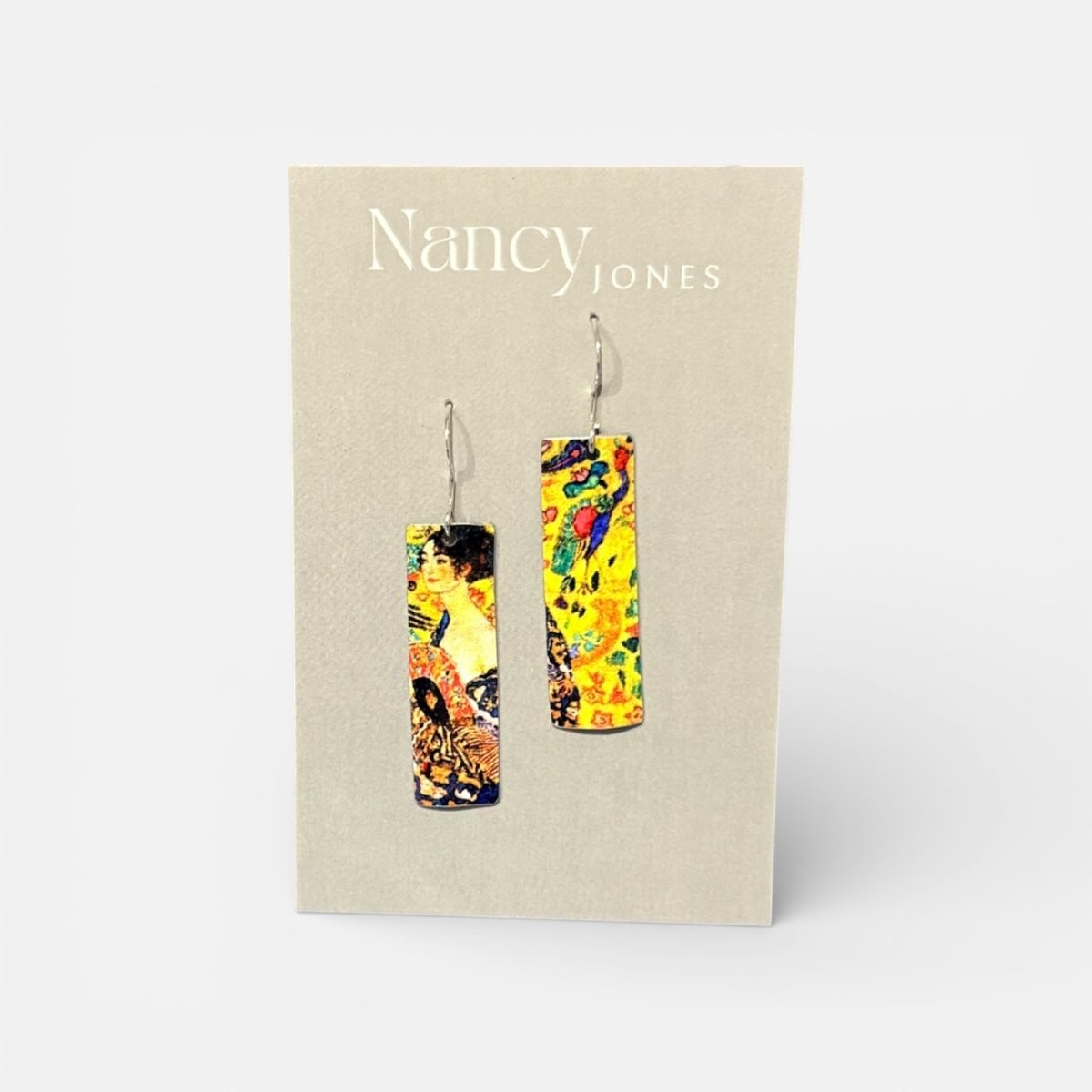 Colorful earrings on a Nancy Jones branded card