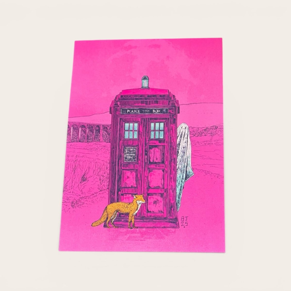 Pink TARDIS with a fox and ghost illustration on a pink background