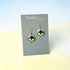 Floral earrings on a Nancy Jones card against a light blue and beige background