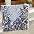 A square art card featuring a stylized floral illustration of snowdrops and crocuses in white, purple, navy, gray, and mustard yellow, leaning against a window ledge.