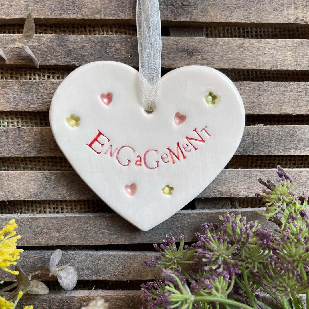Heart-shaped ceramic ornament with &