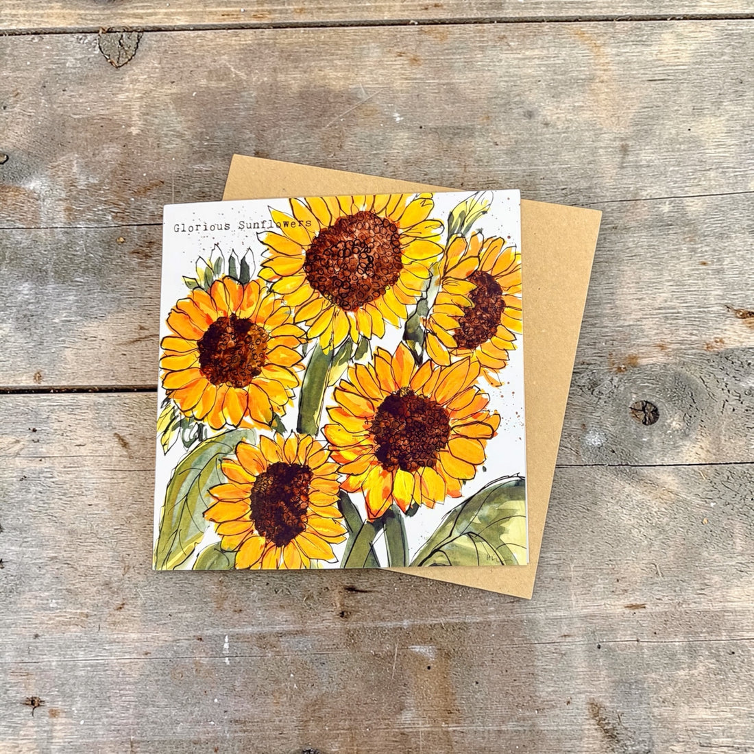 Card with sunflower design on a wooden surface