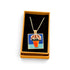 A gold-tone chain necklace with a square pendant featuring a colorful painting of pink flowers in an orange pot, displayed inside an open tan gift box with a black velvet insert on a white background.
