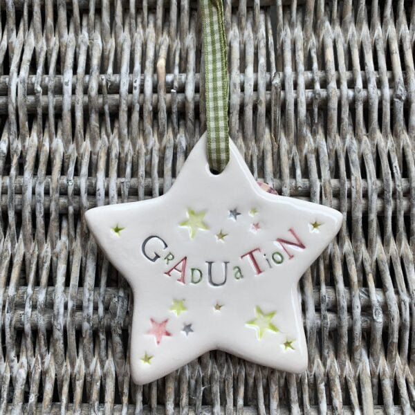 Star-shaped ceramic ornament with &