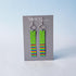 Pair of earrings with colorful patterns on a gray card with &