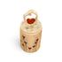 A small cylindrical ceramic keepsake box with a lid, decorated with red heart-shaped flowers on a beige background, featuring a heart-shaped ring topper with a red heart in the center, set against a plain white background.