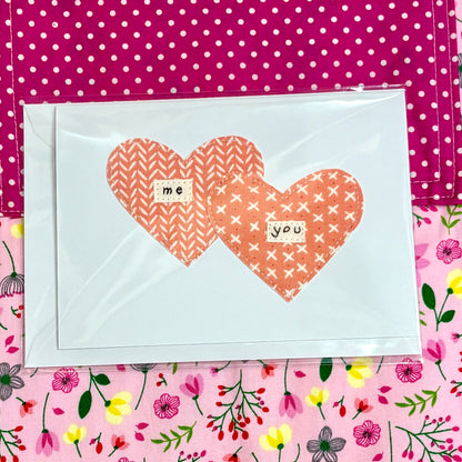 Card with two heart shapes and text on a polka dot and floral patterned background