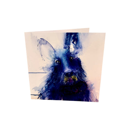 A square greeting card featuring a watercolor-style illustration of a black dog with blue shading on a cream background, shown standing against a plain white backdrop.
