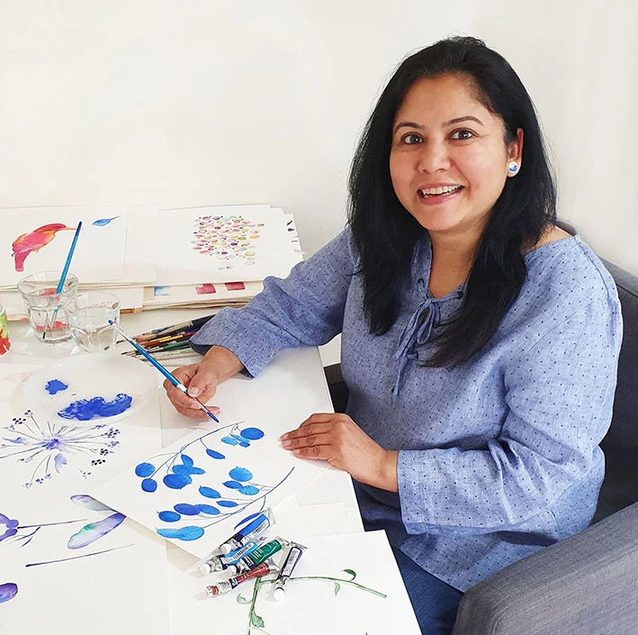 Woman painting with blue watercolors on a white surface_Pattern Passions Profile