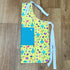 Colorful apron with patterns on a wooden surface_Made by Marianne_Just Makers
