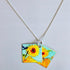 Necklace with a pendant featuring sunflower designs on a light gray background_Nancy Jones_Just Makers
