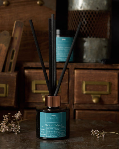 Diffuser with black sticks on a wooden surface with a vintage background_The Kandlers Table_Just Makers