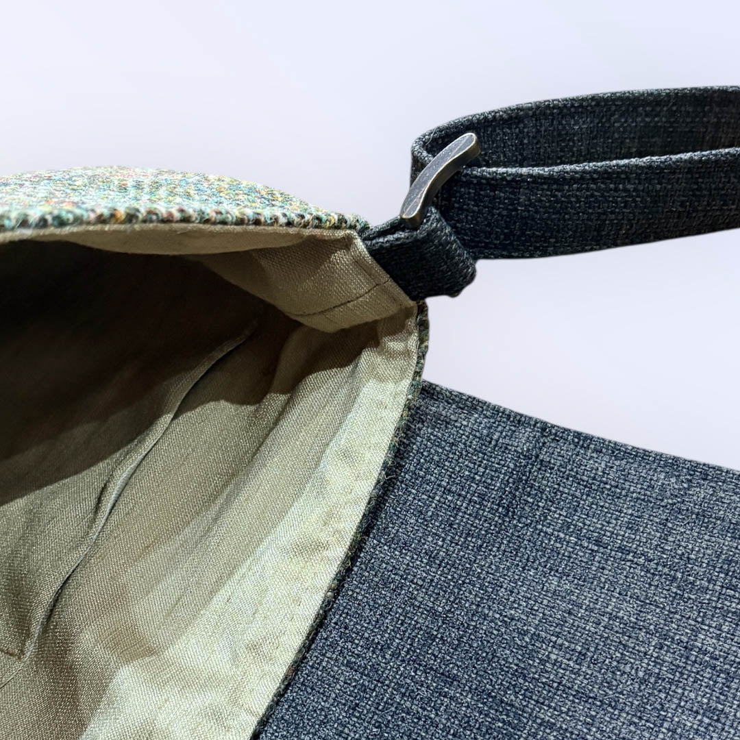 Close-up of a bag with a strap and fabric texture on a white background_Just Makers