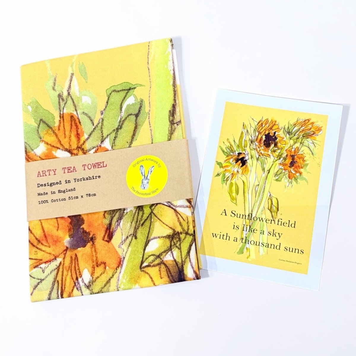 Arty tea towel with sunflower design and matching card on a white background