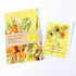 Arty tea towel with sunflower design and matching card on a white background