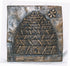 A square bronze relief sculpture depicting a beehive with a bee in the upper right corner, set against a plain white background.