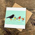 Card with bird illustrations on a wooden surface