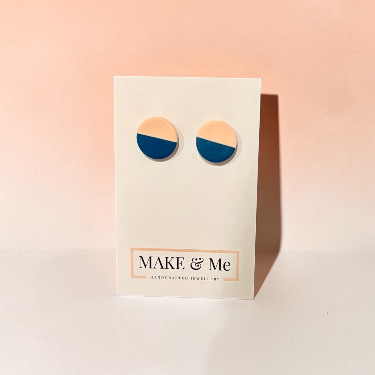 Make &amp; Me earrings on a branded card with a pink gradient background
