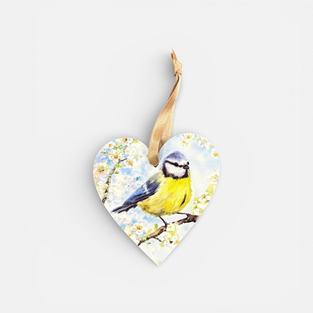 Heart-shaped wooden ornament with a painted bird and flowers on a white background