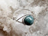 Silver ring with a blue stone on a crystal background